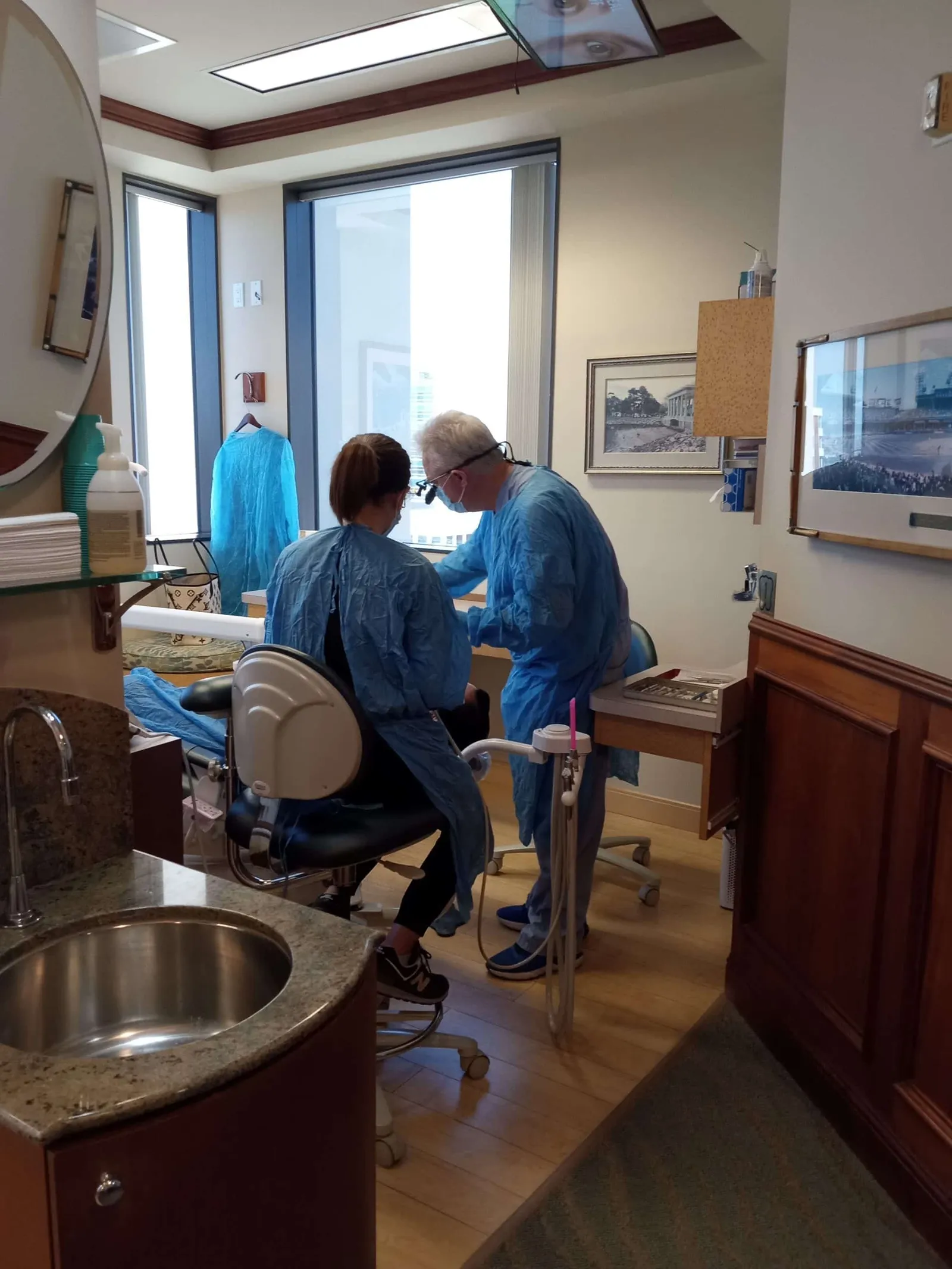 Dr. Sabourin and his assistant treating a patient in a sunlit treatment room in Suite 760