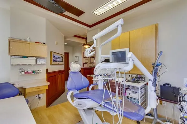 A treatment room with large windows overlooking the city